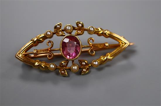 A late Victorian 15ct, pink tourmaline and seed pearl set elliptical brooch, 34mm.